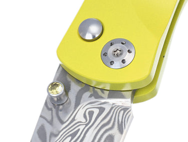 Tesoro Damasteel Button Lock 3½" — Corvette Fordite / Yellow Cerakote, Sapphire Thumb Stud — Closeup